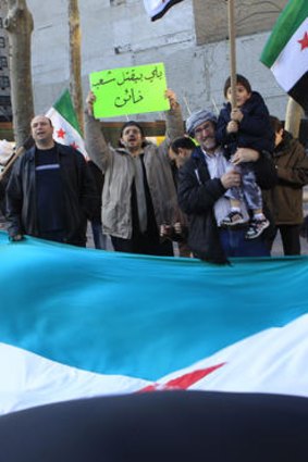 Demonstrators chant slogans and wave Syrian flags outside United Nations headquarters in New York.
