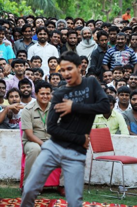 An inmate struts his stuff in front of other prisoners at the Tihar jail in New Delhi.