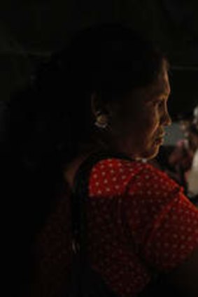 Memorial: At a human rights protest in Colombo - held to coincide with CHOGM - Mariyamma Karankaran lights a candle in remembrance of her son, who disappeared in 2006.