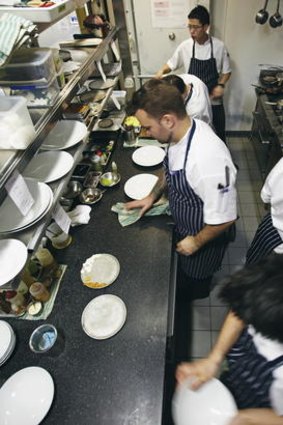Staff at work in the compact Marque kitchen.