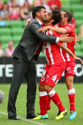 Safe at last: Andrea Migliorini of the Heart celebrates with coach John Aloisi after scoring.