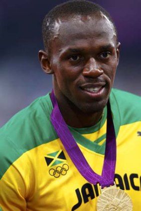 Usain Bolt poses with his gold medal after winning the men's 200m event at the London 2012 Olympic Games. AFL chief executive Andrew Demetriou said he had invited the world's fastest man to the Grand Final