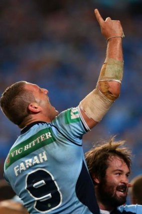 Heartfelt tribute: NSW vice-captain Robbie Farah points to the heavens after the Blues won 6-4 in a nail-biting second State of Origin match on Wednesday night.