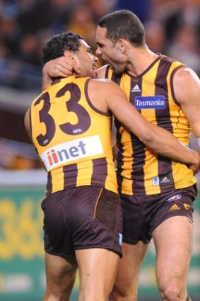 Thriller: Cyril Rioli (left) and Shaun Burgoyne celebrate breaking the curse in the preliminary final last year.