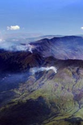 The crater of Indonesia's Mount Tambora. Its eruption in 1815 was the largest in recorded history. Its volcanic ash and gas travelled the world, causing bright red and orange sunsets.