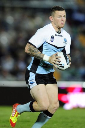 Todd Carney of the Sharks runs the ball during the round four NRL match between the North Queensland Cowboys and the Cronulla Sharks.