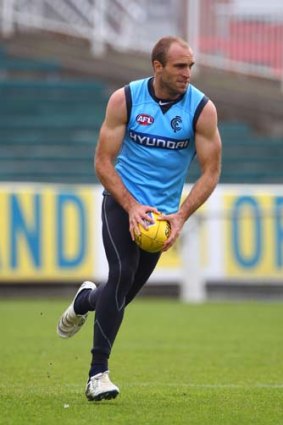 Chris Judd of the Blues runs with the ball during a Carlton Blues AFL training session at Visy Park this week.