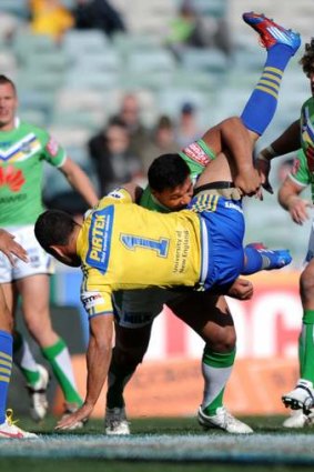 Raiders enforcer Josh Papalii drives Parramatta's Jarryd Hayne into the turf in 2012. The pair will be teammates in 2014.