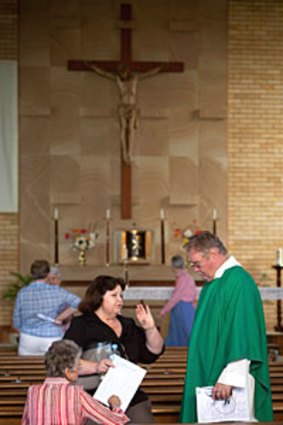 Father John Conway speak to parishioners after the service in Gatton.