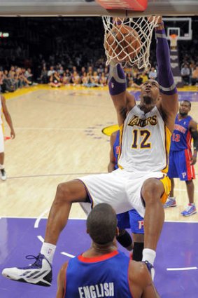 Los Angeles Lakers centre Dwight Howard dunks on Detroit Pistons guard Kim English.