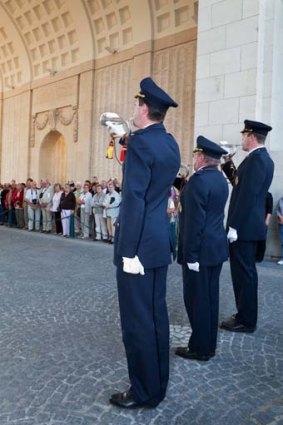 Buglers from the firefighting corps playing the Last Post under the Menin Memorial Gate.
