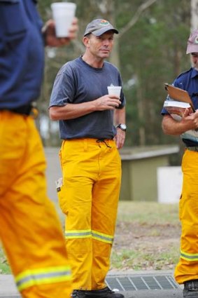 Volunteer &#8230; opposition leader, Tony Abbott, listens to a bushfire briefing.