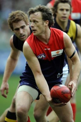 Melbourne's James McDonald gets ready to handball in the round 18 game against Richmond in 2009. The Demons lost by four points.