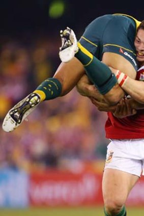 Heavy load: George North takes Israel Folau for a ride during a British and Irish Lions game in June.
