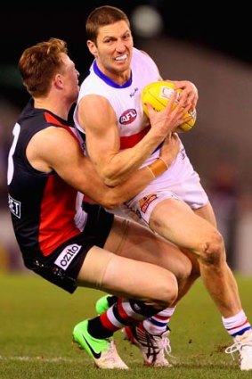 Leashed: Bulldog Matthew Boyd is stopped in a tackle by St Kilda's Brendon Goddard.