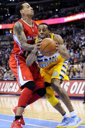 Denver Nuggets guard Andre Iguodala (right) drives past Los Angeles Clippers forward Matt Barnes during the fourth quarter.
