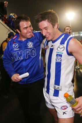 A delighted Kangaroos coach Brad Scott celebrates the win with Sam Wright.