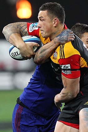 Back in business ... Sonny Bill Williams offloads in the tackle of Tamati Ellison.