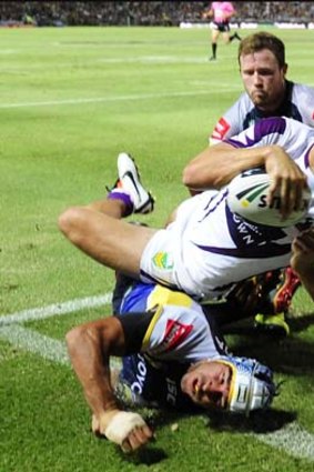 Just missed it: Storm's Matt Duffie unsuccessfully attempts to score a try against North Queensland.