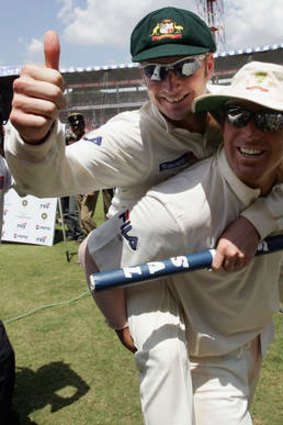 Back in the day: Michael Clarke (back) and Shane Warne celebrate a test win in India, in 2004.