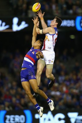 Darcy Gardiner marks over the top of Lin Jong of the Bulldogs.