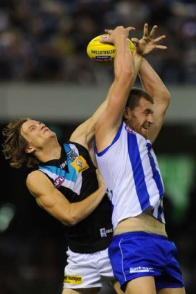 North Melbourne's Lachie Hansen marks ahead of Port's Jared Polec during the round three game on Sunday.