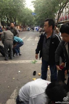 People reacting to the explosions in a marketplace in Urumqi. (Via Weibo)