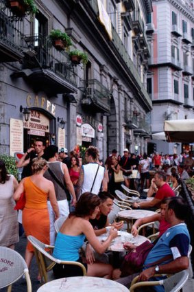 Street cafe and pedestrians in Piazza Trento e Trieste.
