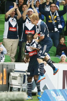 On high: Mitch Nichols leaps on to goalscorer Adama Traore during the Victory's 2-0 win over Perth Glory at AAMI Park.