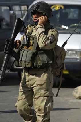 An Iraqi soldier stands guard in Sadr City in Baghdad.