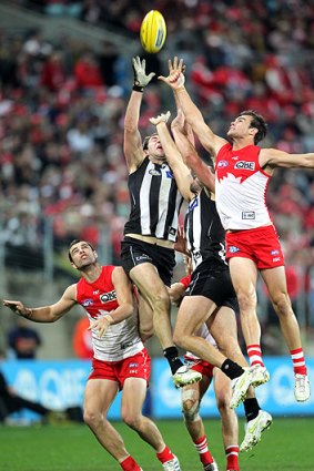 Big grab: Collingwood forward Travis Cloke flies in the middle of a pack during the Magpies scrappy win over the Swans at Sydney's ANZ Stadium last night.