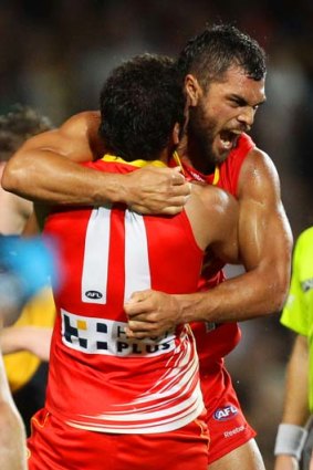 Karmichael Hunt celebrates with Harley Bennell after kicking the winning goal.