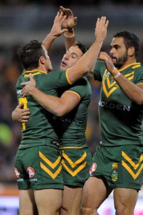 Cooper Cronk (left) and Billy Slater (centre) with Greg Inglis.