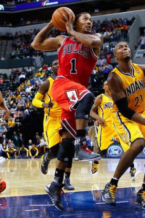 Back in action: Chicago Bulls star Derrick Rose takes the ball to the hoop against David West of the Indiana Pacers at Bankers Life Fieldhouse.