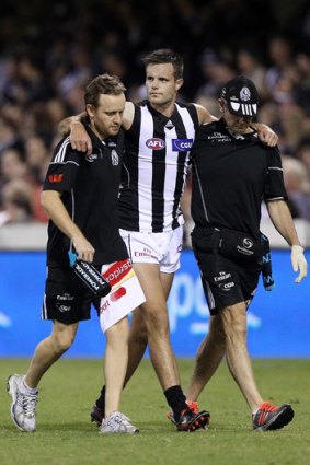 Nathan Brown is helped from the field after being injured during Collingwood's round seven match against the Brisbane Lions.