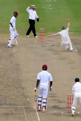 Legacy: part-time leg spinner David Warner claims a caught-and-bowled against West Indies batsman Kirk Edwards in Bridgetown.