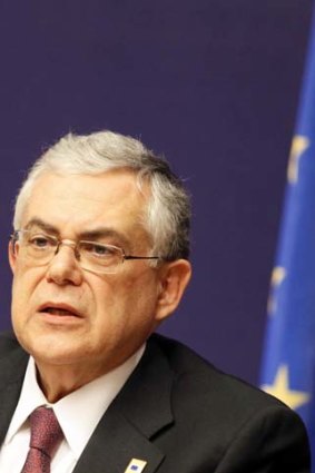 Greece's prime minister Lucas Papademos may be the bearer of bad news if his country is cut from the European Union.