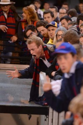 Angry Demons supporters yell abuse.
