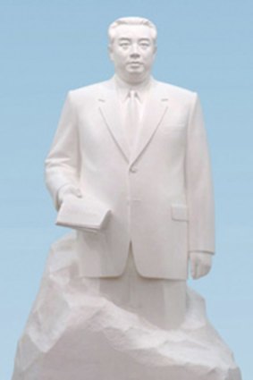 Kim Jong-il, in front of a statue of his father, Kim Il-sung, at the Workers Party Conference in Pyongyang.