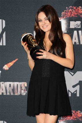 Actress Mila Kunis poses in the press room at the 2014 MTV Movie Awards at Nokia Theatre L.A. Live on April 13, 2014 in Los Angeles, California.