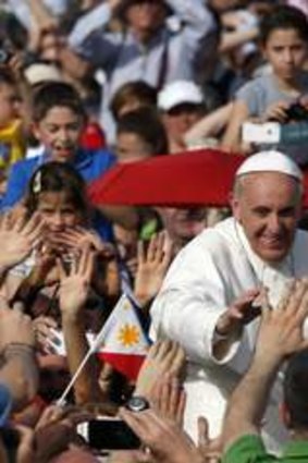 Pope Francis waves as he arrives to lead a Pentecost vigil mass in Saint Peter's Square at the Vatican.
