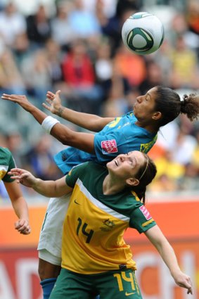 Up, up: Brazilian striker Cristiane and Australian midfielder Collette McCallum fight for the ball.