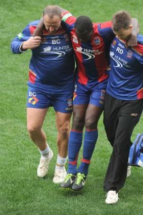 Newcastle Jets' Emile Hesky is carried off during a closed practice match at AAMI Park against Melbourne Victory.