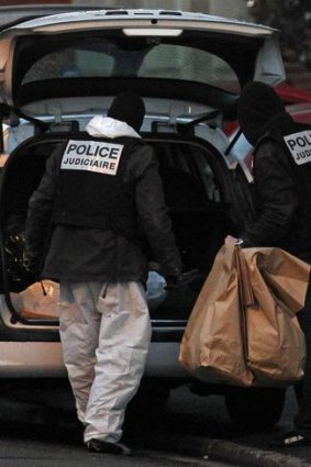 French police carry bags containing evidence outside the five-storey apartment building special forces police killed gunman Mohamed Merah in Toulouse.