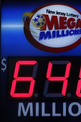 A storefront sign displays the jackpot total of the Mega Millions lottery in Hoboken, New Jersey.
