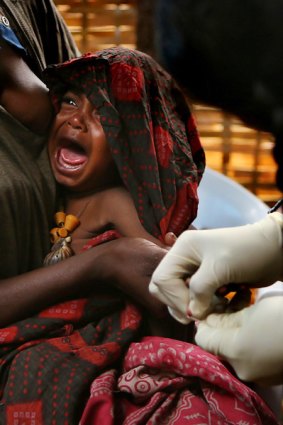 Mitchu Bosha, 1, is given an appetite test at a clinic in the village of Allelu.