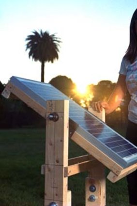 Eden Full, 20, a Thiel Fellowship recipient, with her rotating solar panel, which she calls the SunSaluter, near her home in Oakland, California.