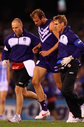 Kepler Bradley is helped off the ground after a head clash.