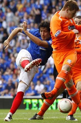Francisco Sandaza of the Rangers attempts a shot at goal past East Stirling's Rhyss Devlin (front) during the Scottish Football League division three match at Ibrox stadium in Glasgow.