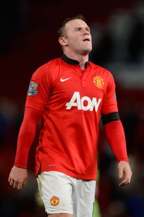 Wayne Rooney looks dejected upon hearing the final whistle.